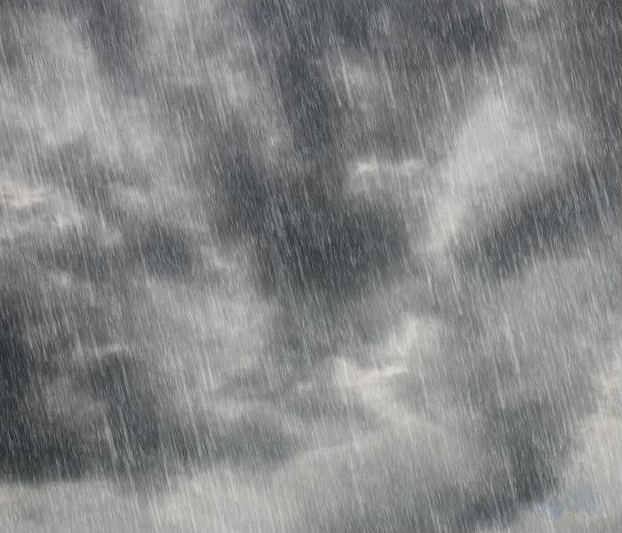 dark gray cloudy sky with heavy rain droplets pouting in front of it